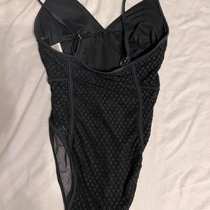 NWOT women crochet style one piece swim suit brand is Cali For Nia